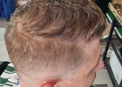 Trendy taper haircut at Mike Hairstylist / Barber, Sandton, Gauteng, ZA showcasing expert styling.