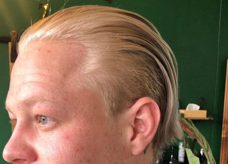 Side view of sleek blonde hairstyle at Mike Hairstylist / Barber, Sandton, Gauteng, ZA.