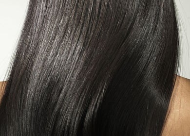 Close-up of silky, smooth black hair at Salon Mehik in Montréal, Québec, CA, showcasing expert hair treatments.