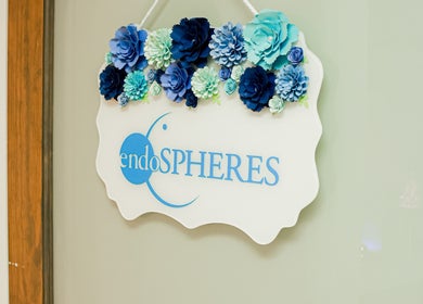 Decorative sign with blue flowers at SkinSation Endospheres Wellness & Massage, Mount Pleasant, South Carolina, US.