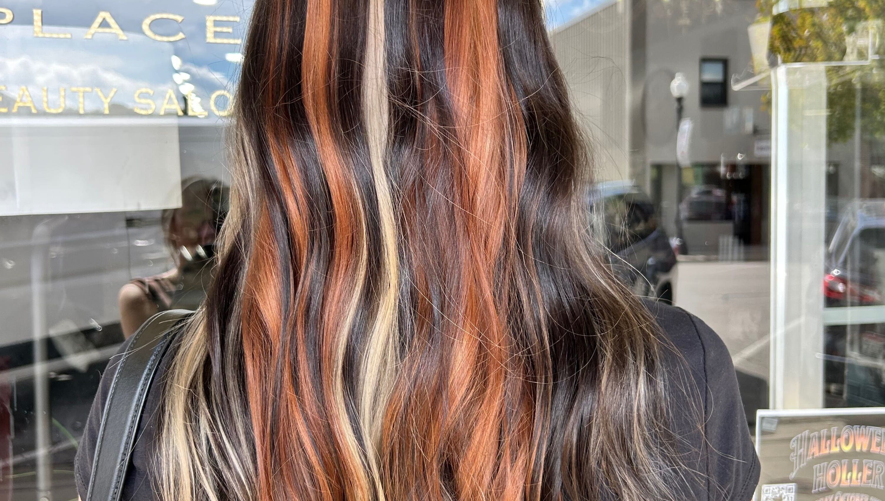 Vibrant hair coloring at Danielle Chew salon in Atchison, Kansas, US, showcasing stylish multicolor waves.