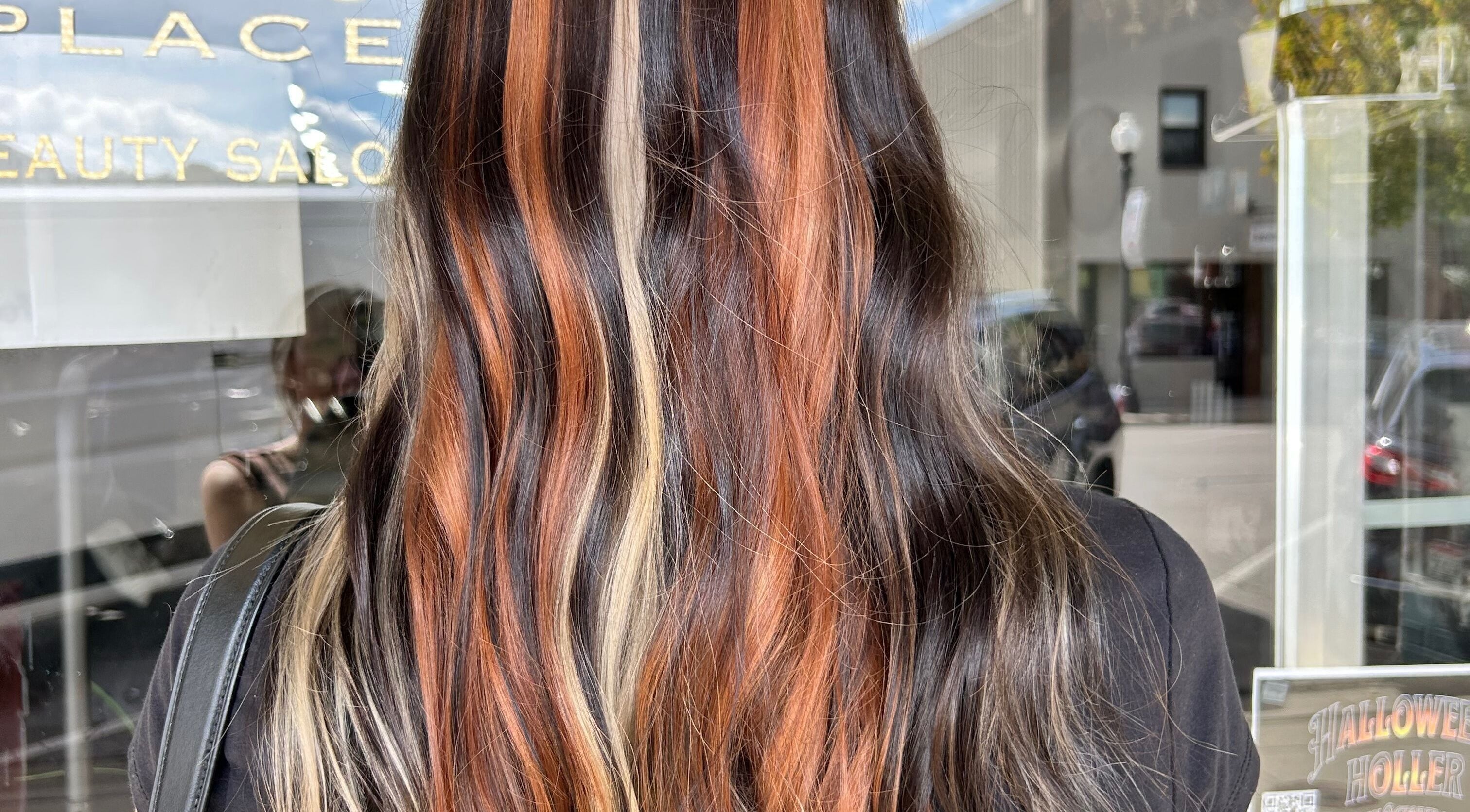 Vibrant hair coloring at Danielle Chew salon in Atchison, Kansas, US, showcasing stylish multicolor waves.