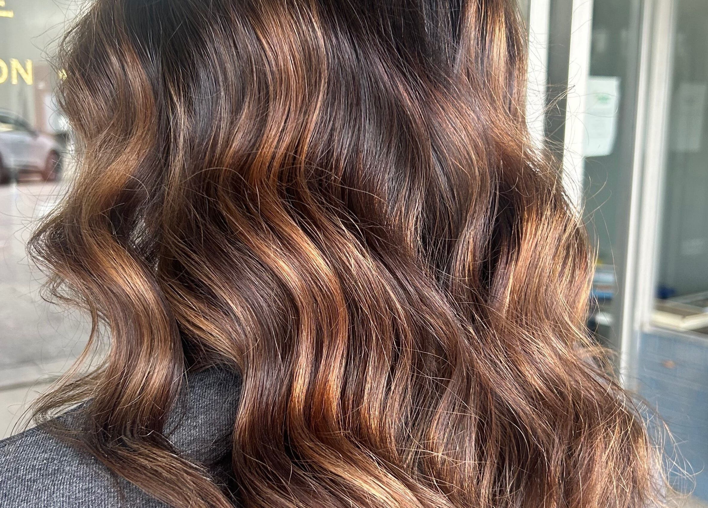 Luxurious wavy brunette hair styled at Danielle Chew in Atchison, Kansas, US.