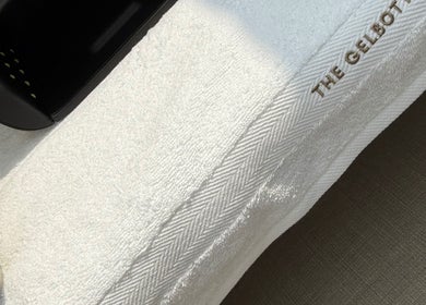 A sleek nail dryer on a soft towel at The NAIL ENVY Bar, Cardiff, Wales, GB showcasing luxury and comfort.