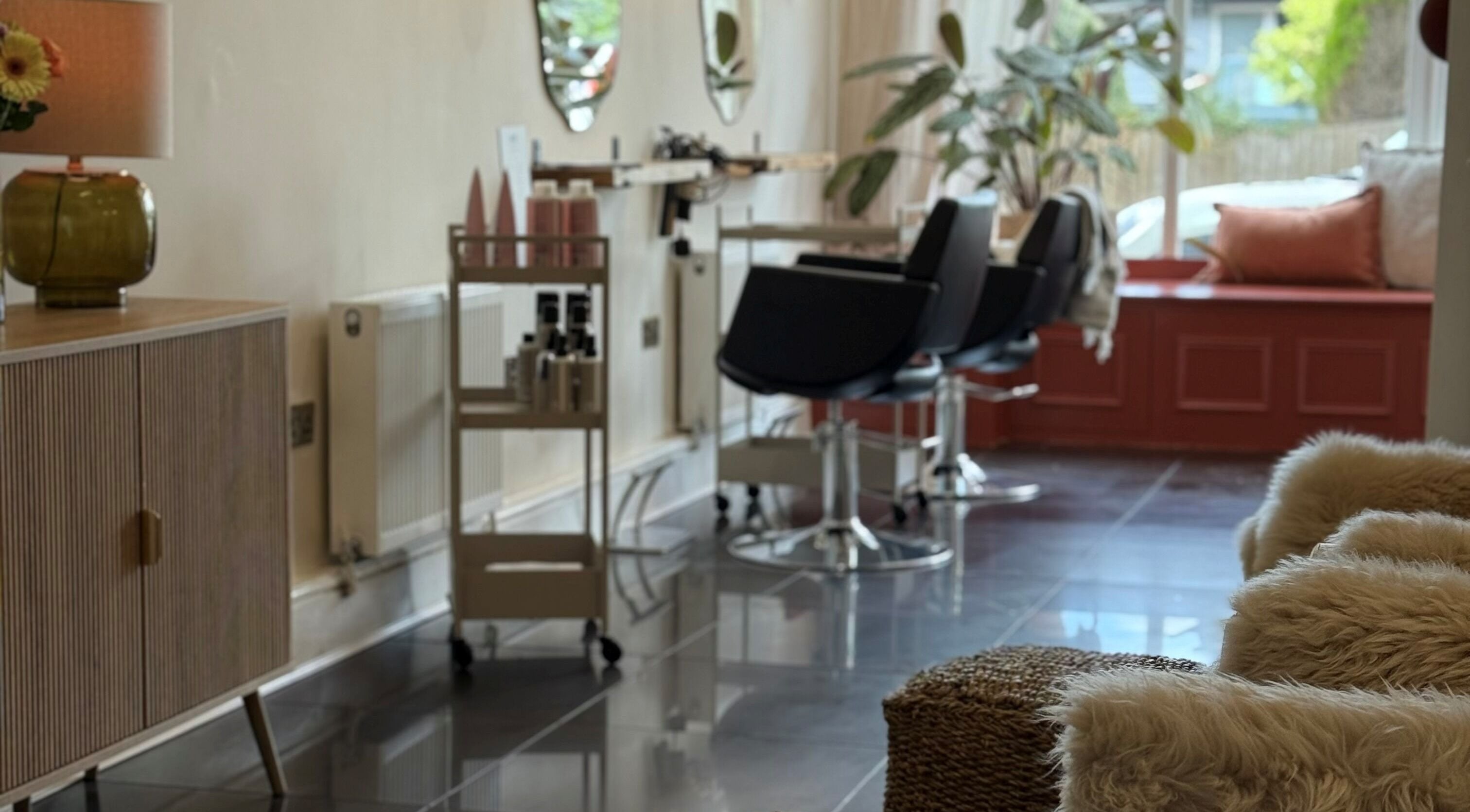 Modern interior of Beau Hair Studio in Astwood Bank, England, GB featuring stylish seating and decor.