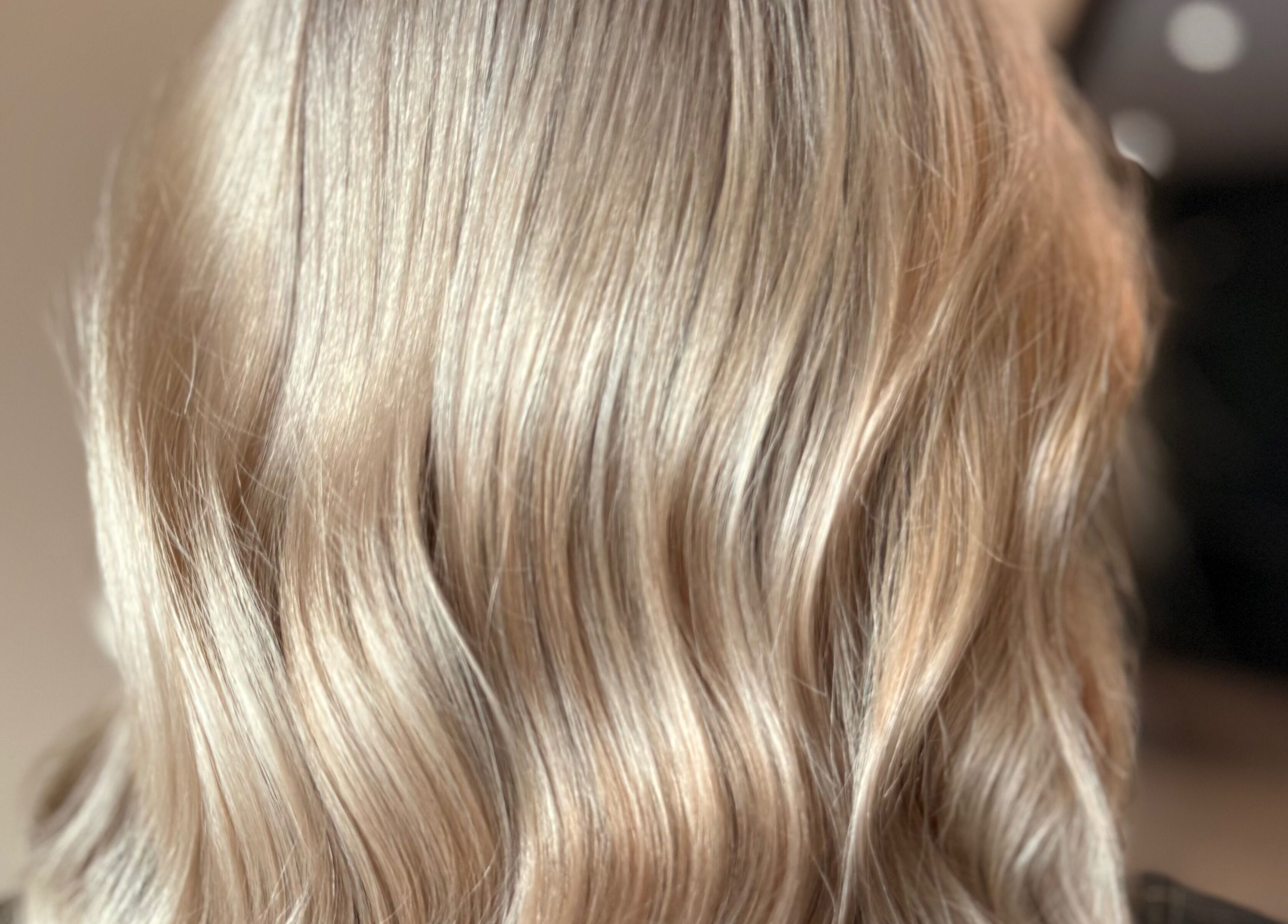 Close-up of wavy blonde hair styled at Studio B – Bruce Johnstone Hairdressing, Dundee, Scotland, GB.