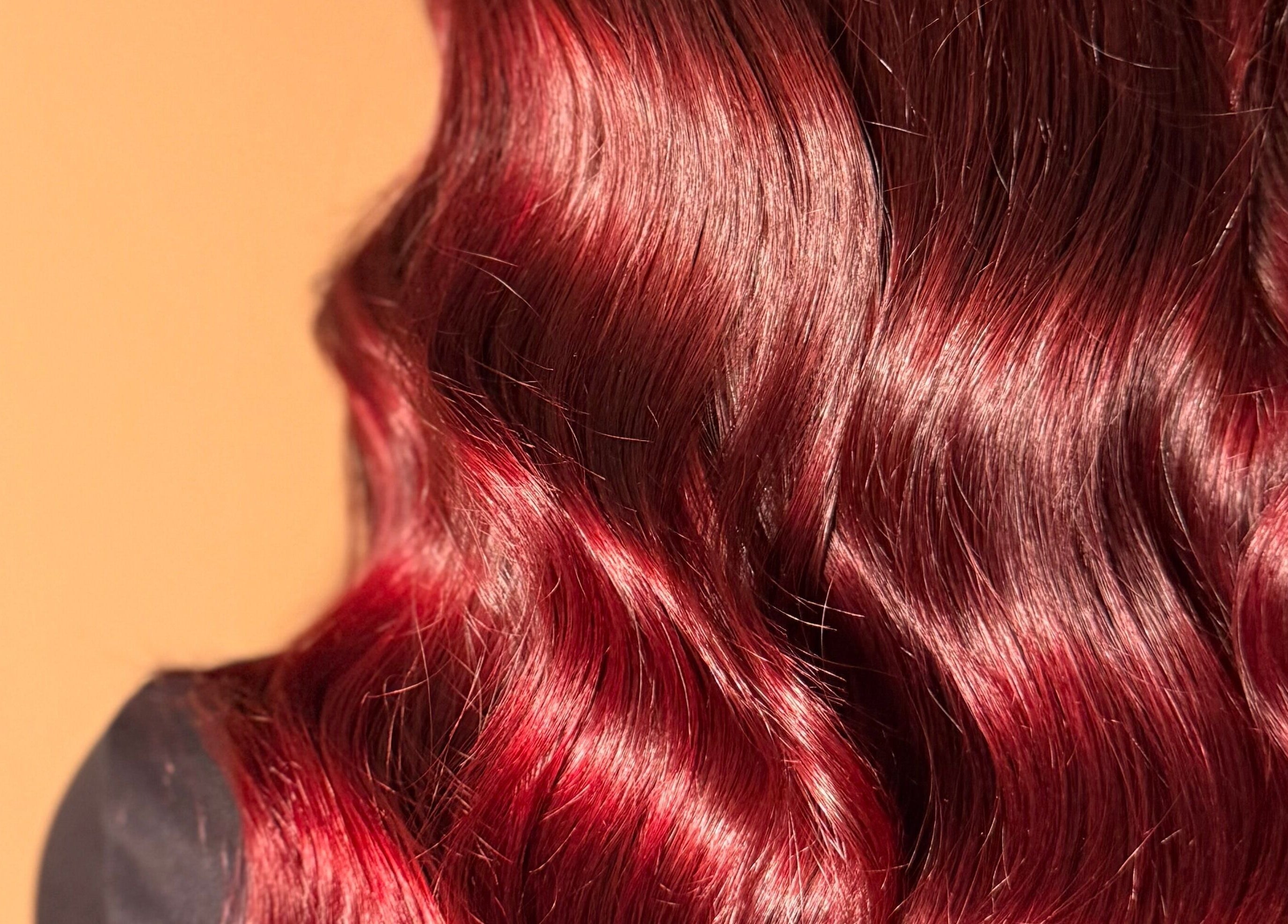 Lustrous red hair styled in soft waves at Studio B – Bruce Johnstone Hairdressing, Dundee, Scotland, GB.