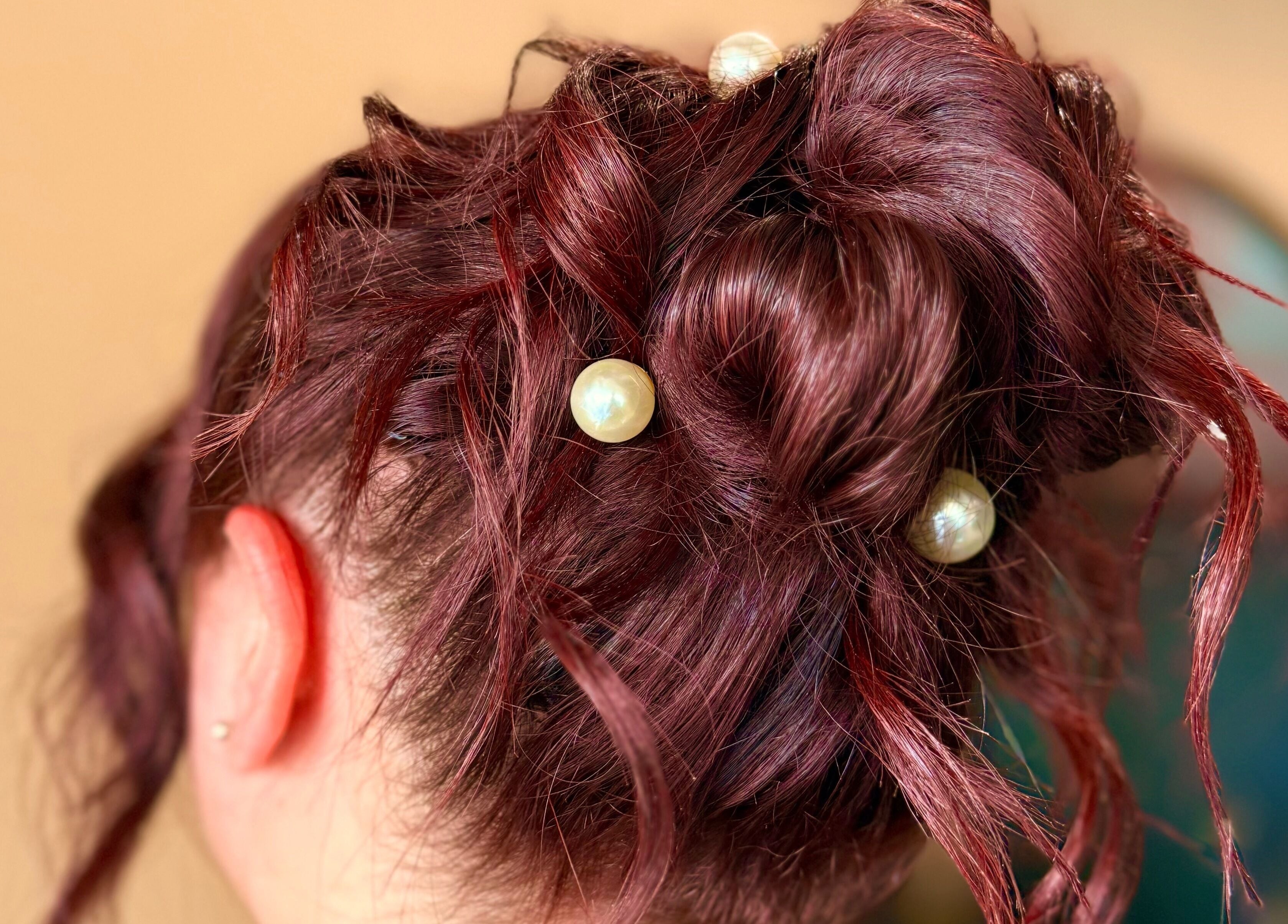 Elegant pearl-adorned updo hairstyle at Studio B – Bruce Johnstone Hairdressing, Dundee, Scotland, GB.