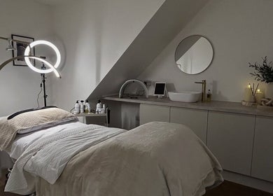 Relaxing treatment room at Skin Space by Lauren in Worsley, England, GB featuring modern decor and ambient lighting.