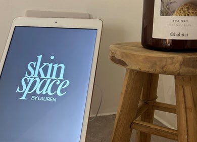 Skin Space by Lauren, Worsley, features an inviting spa setup with digital logo and scented candle.