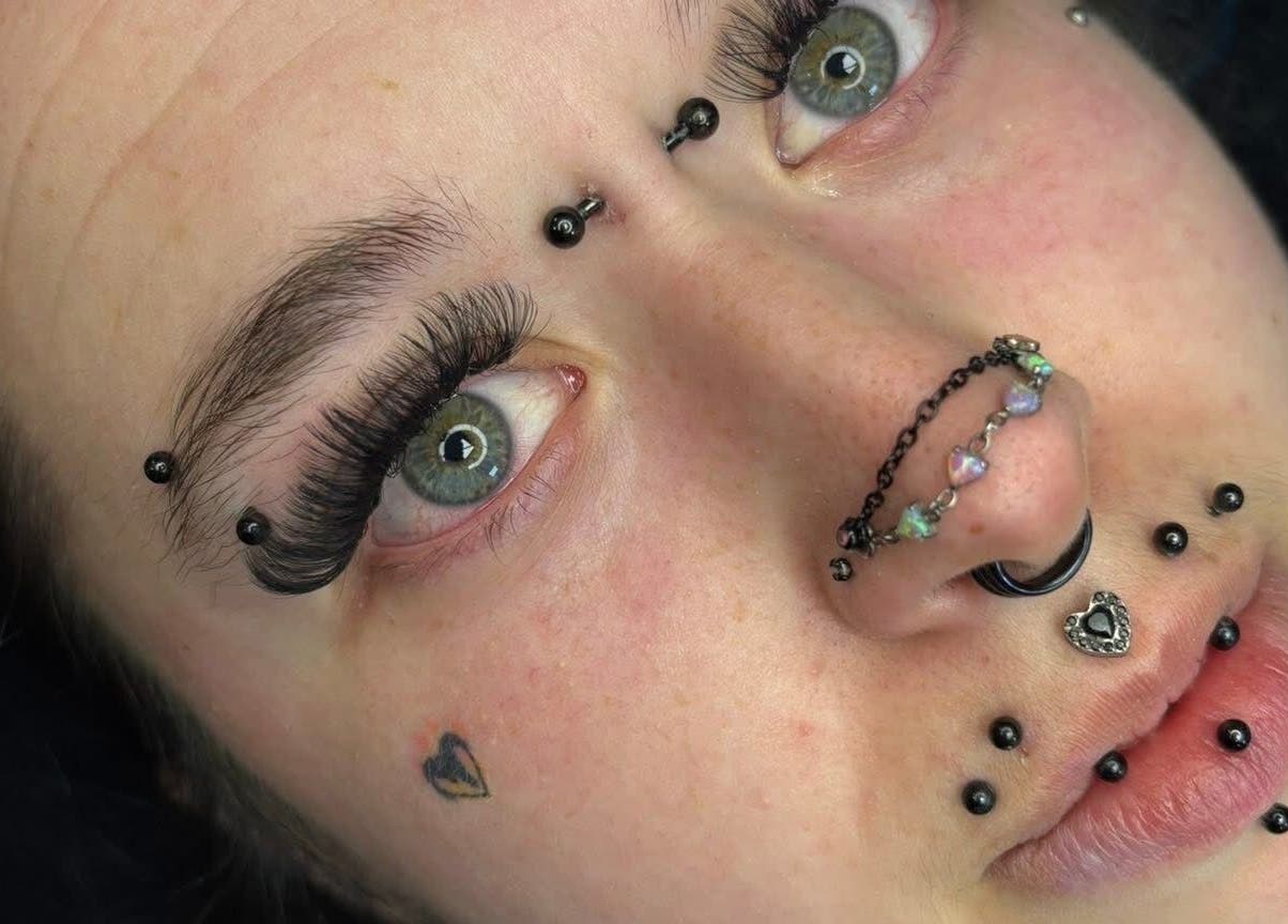 Close-up of eye with dramatic lashes by Lashesbyjazminexo, Parkgate, England, GB featuring unique piercings.