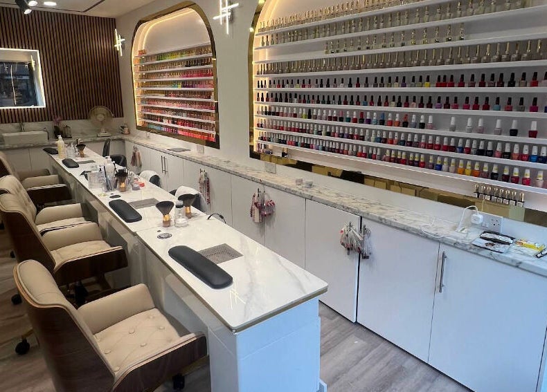 Elegant manicure station at Belle Ame Beauty Champagne Lounge in London, England, GB with vibrant polish display.