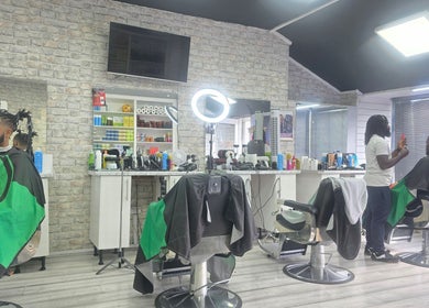 Modern interior of Ob's Barbers, Nottingham, England, GB, showing stylists at work in a sleek setting.
