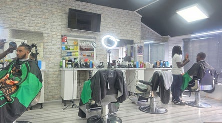 Modern interior of Ob's Barbers, Nottingham, England, GB, showing stylists at work in a sleek setting.