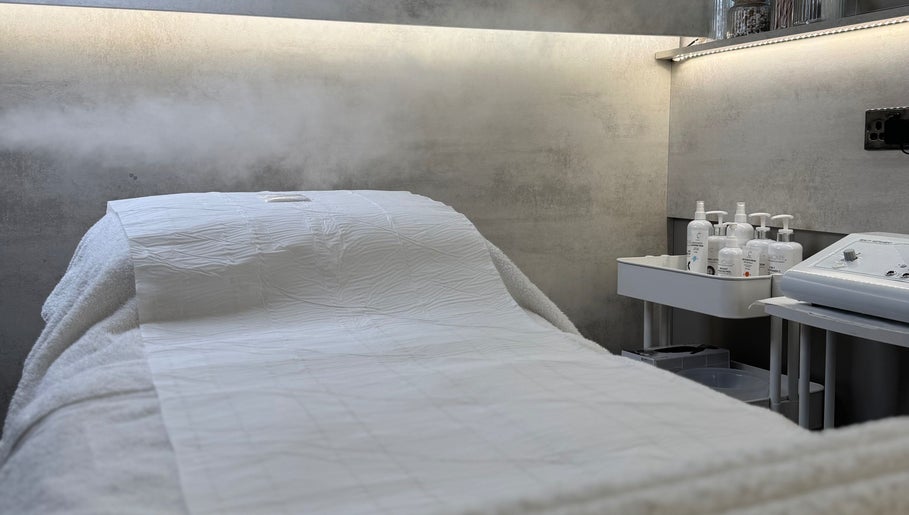 Relaxing treatment room at SkinCure, Castleford, England, GB with a comfortable spa bed and skincare products.