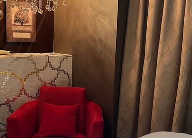 Luxurious seating area at Zencure, Richmond, British Columbia, CA with plush red chair and elegant decor.