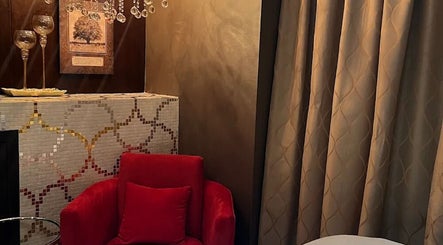 Luxurious seating area at Zencure, Richmond, British Columbia, CA with plush red chair and elegant decor.