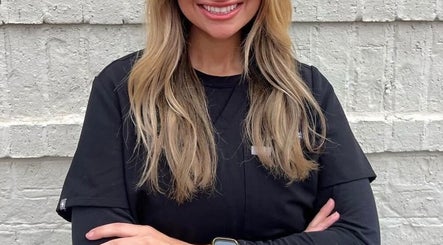 Smiling beauty professional at The Daily Glow LLC, Tuscaloosa, Alabama, US, showcasing service excellence.
