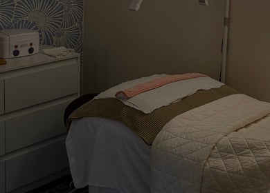Cozy spa room at The Daily Glow LLC, Tuscaloosa, Alabama, US with a neatly made treatment bed.