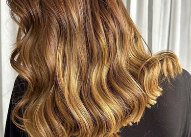 Glossy brown hair with waves at Rainbows By Mariana in Rockford, Illinois, US.