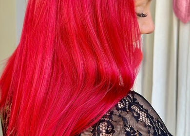 Vibrant red hair transformation at Rainbows By Mariana, Rockford, Illinois, US, showcasing stunning color intensity.