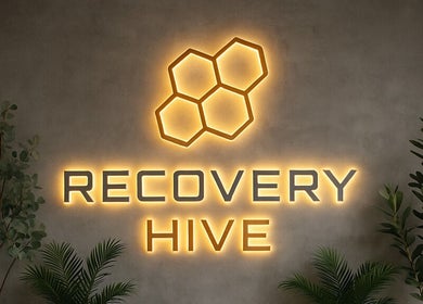Illuminated Recovery Hive sign with plants, situated at Coolum Beach, Queensland, AU.