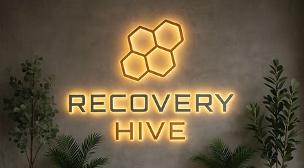 Illuminated Recovery Hive sign with plants, situated at Coolum Beach, Queensland, AU.
