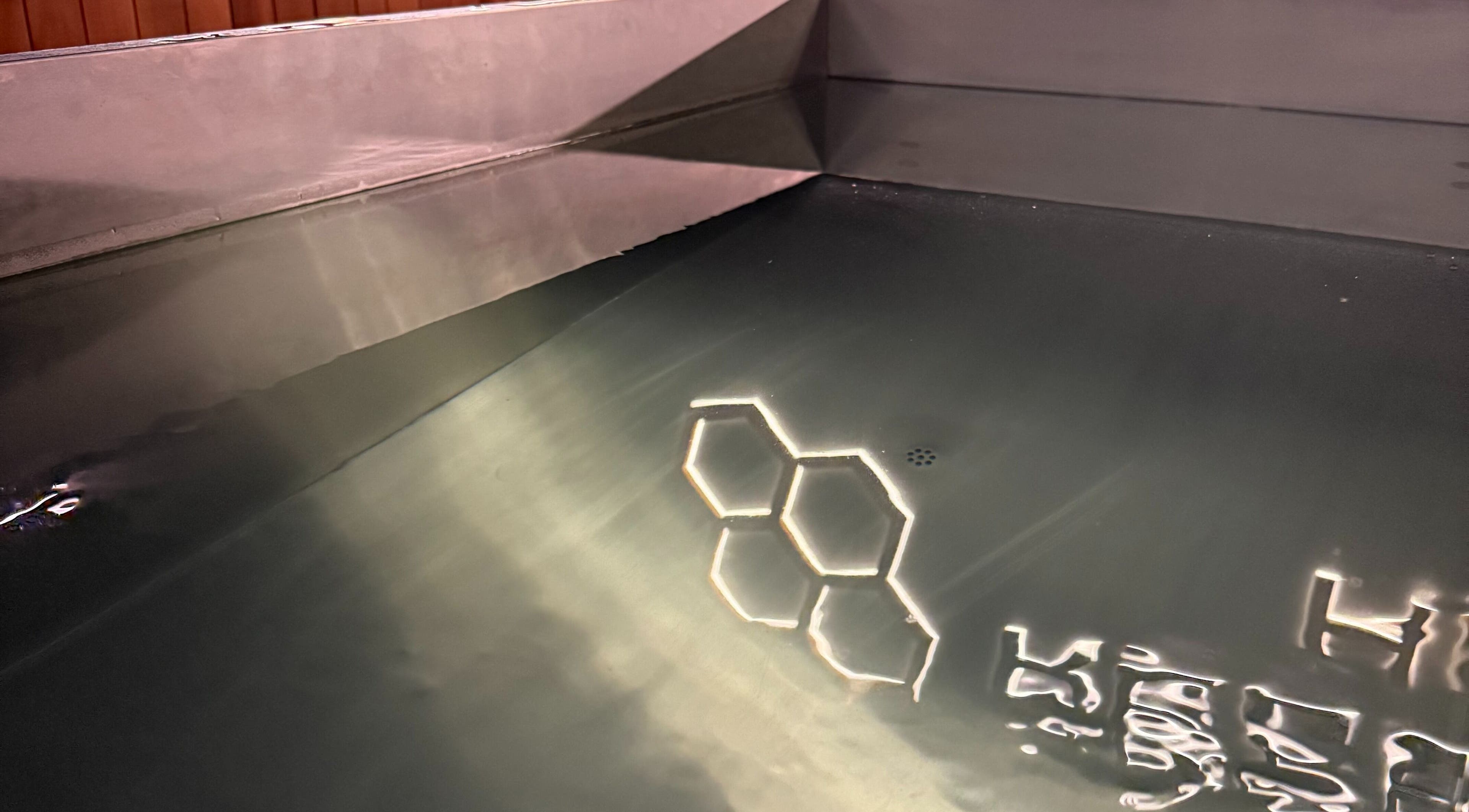 Calming spa bath at Recovery Hive, Coolum Beach, Queensland, AU, reflecting geometric patterns.