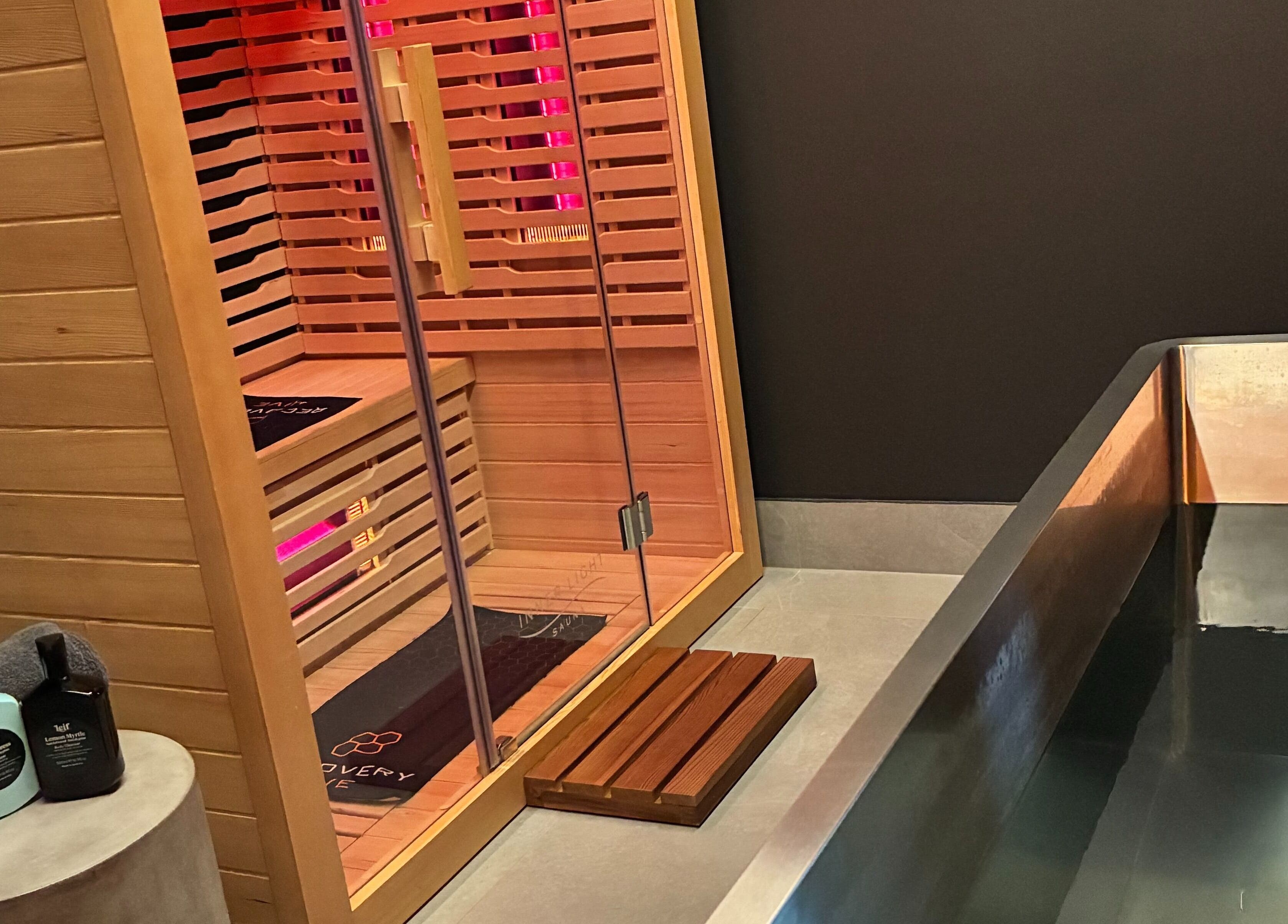 Tranquil sauna room at Recovery Hive, Coolum Beach, Queensland, AU featuring wooden interior and spa essentials.
