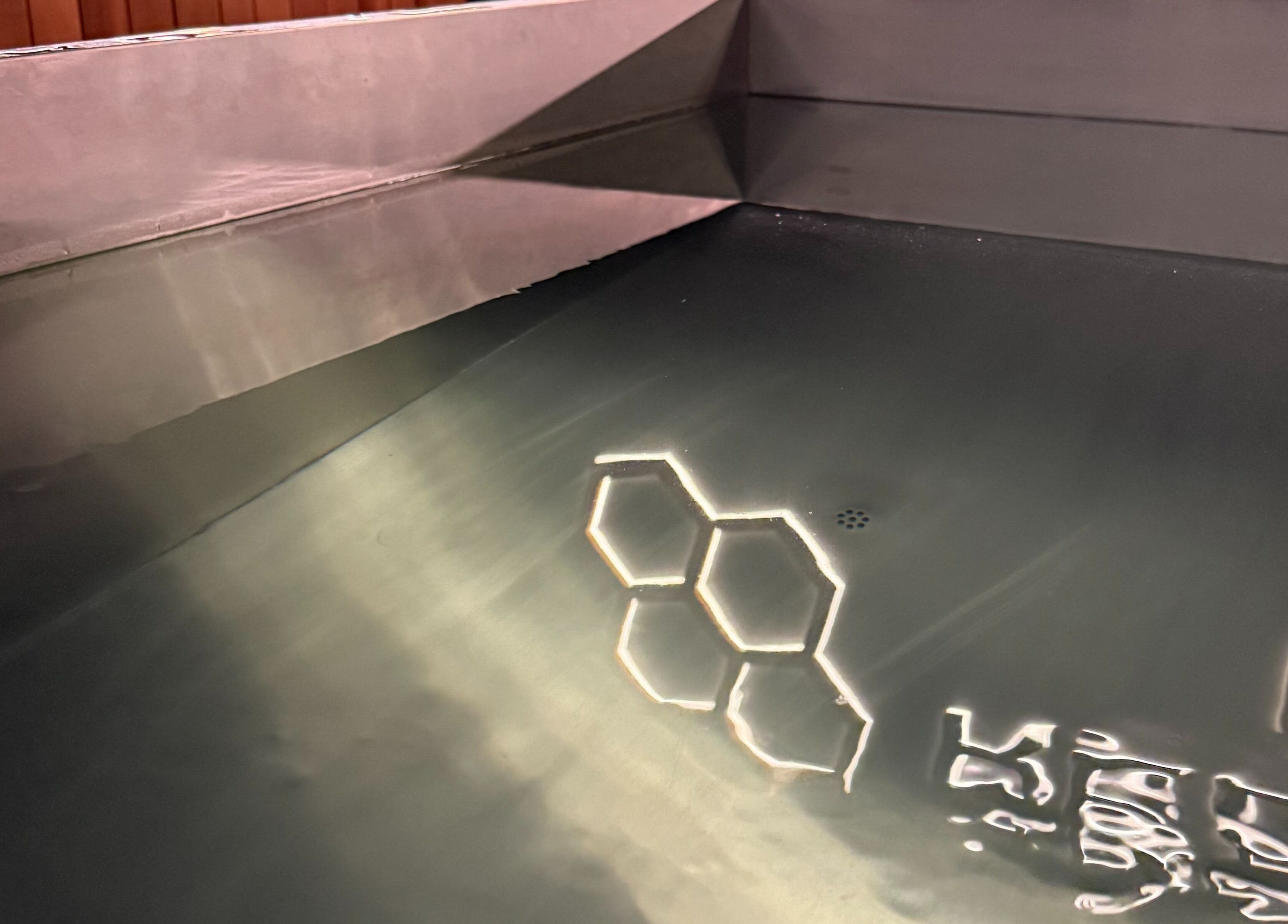 Water surface with hexagonal reflections at Recovery Hive, Coolum Beach, Queensland, AU.