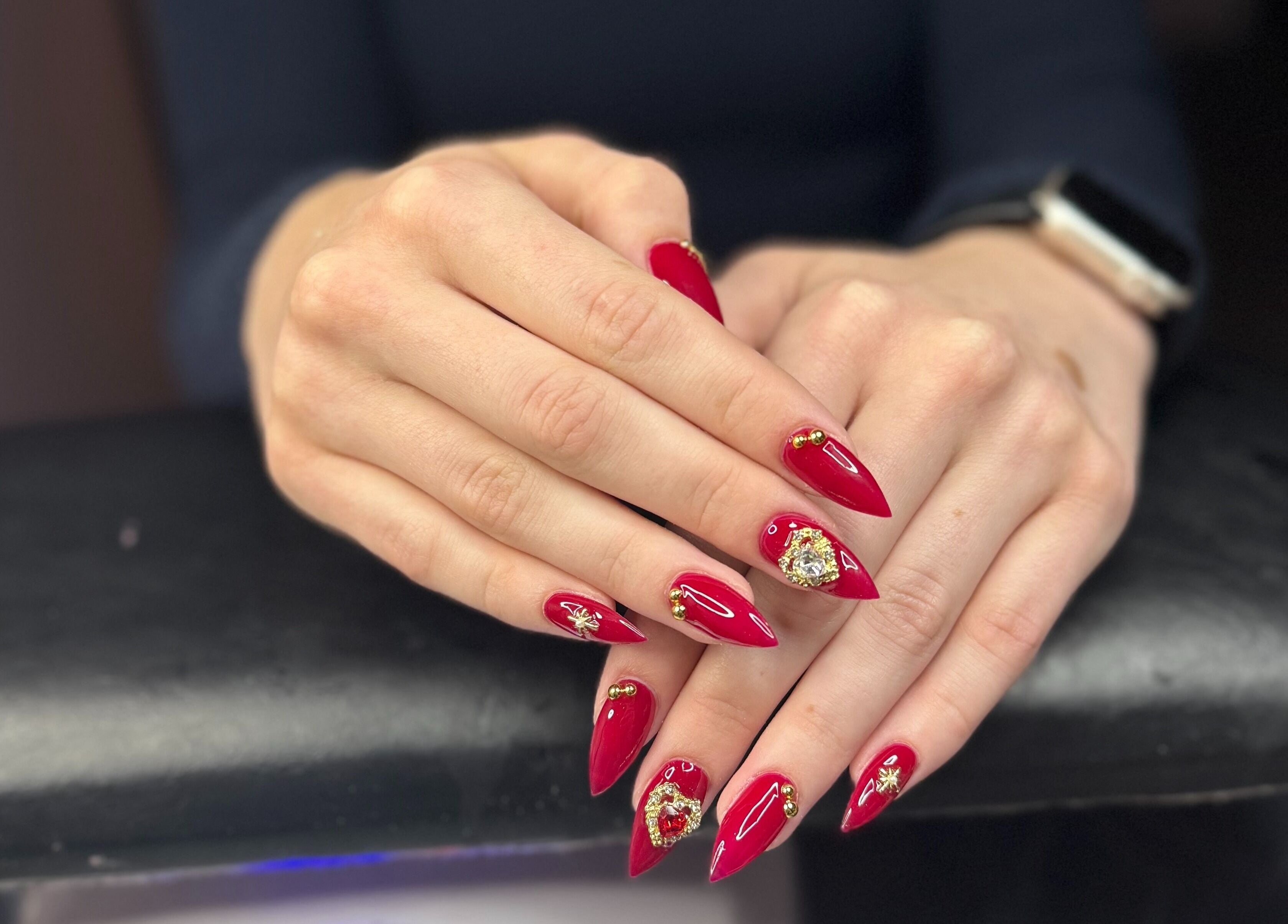 Red nail art with gems at PolishedByPaigie in Lloydminster, Alberta, CA. Stunning manicure design.