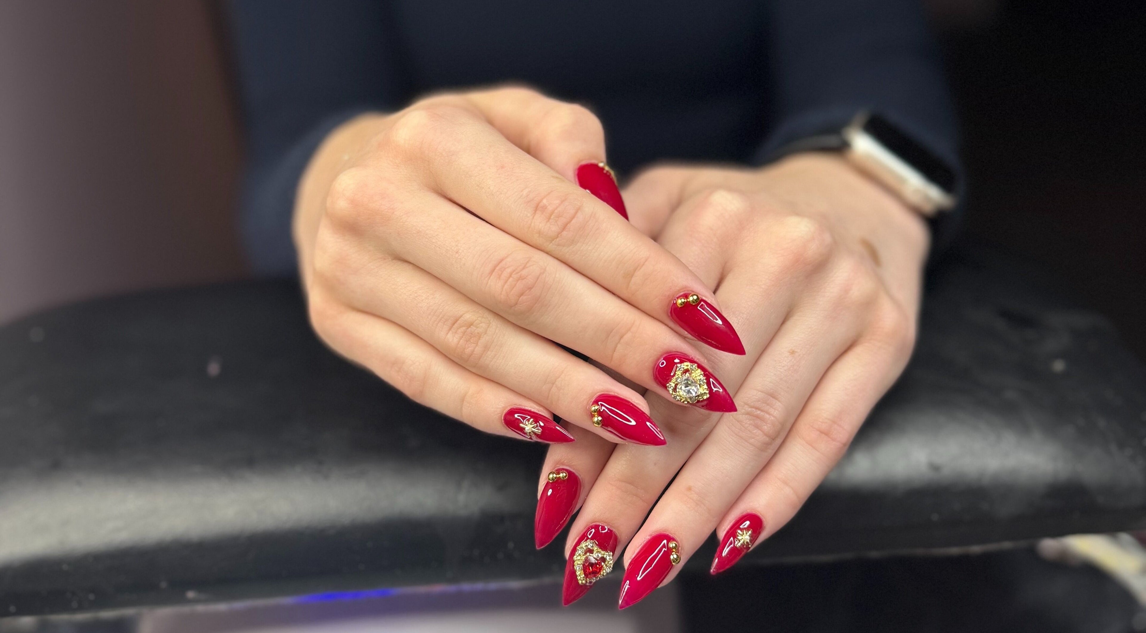 Red nail art with gems at PolishedByPaigie in Lloydminster, Alberta, CA. Stunning manicure design.