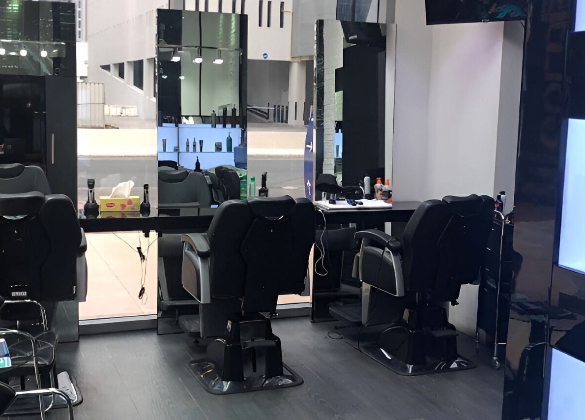 Elegant interior of Ace Barber Shop in Dubai, Dubai, AE, showcasing modern chairs and sleek mirrors.