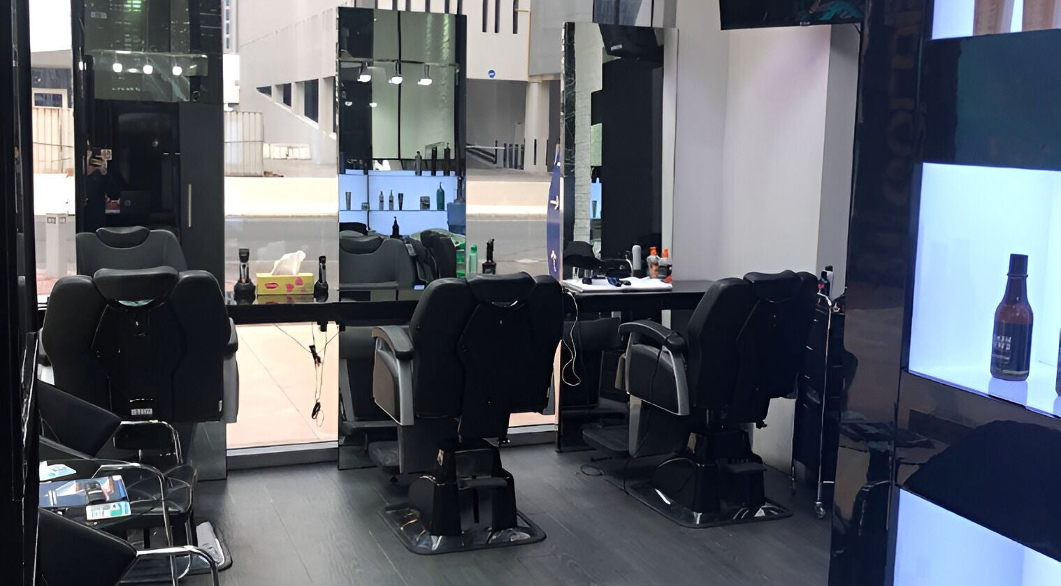 Elegant interior of Ace Barber Shop in Dubai, Dubai, AE, showcasing modern chairs and sleek mirrors.