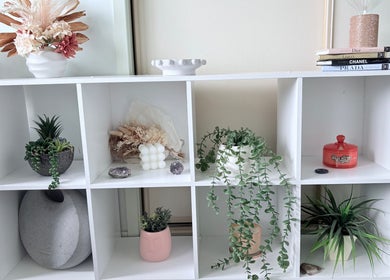 White shelf with decor and plants at Lash Envy Boutique, Lake Haven, New South Wales, AU.