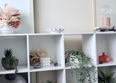 Elegant shelf decor at Lash Envy Boutique, Lake Haven, New South Wales, AU, featuring plants and books.
