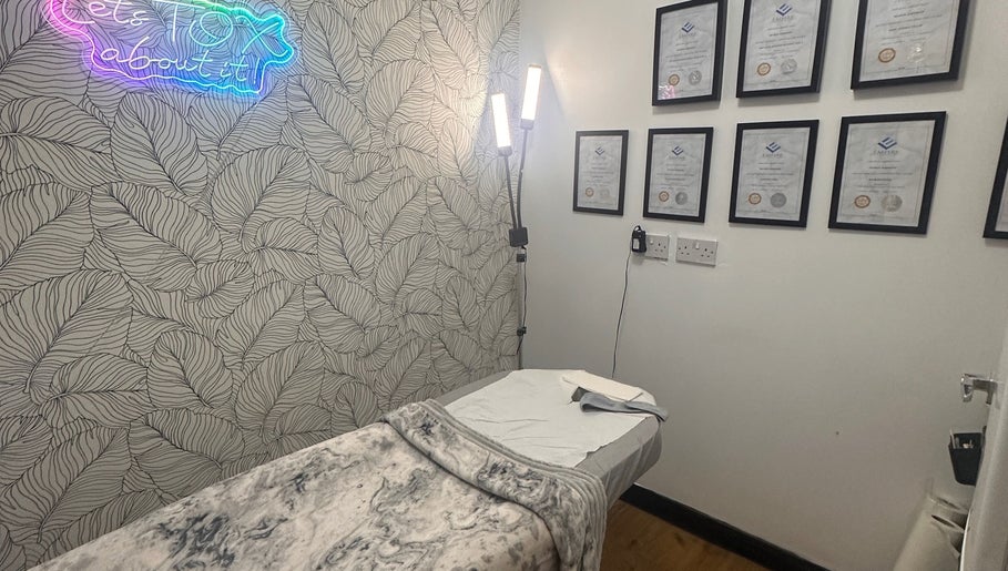 Treatment room at Beauty by Lynz, Kilsyth, Scotland, GB with certificates on wall and cozy massage table.
