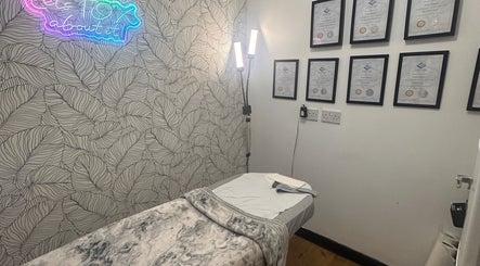 Treatment room at Beauty by Lynz, Kilsyth, Scotland, GB with certificates on wall and cozy massage table.