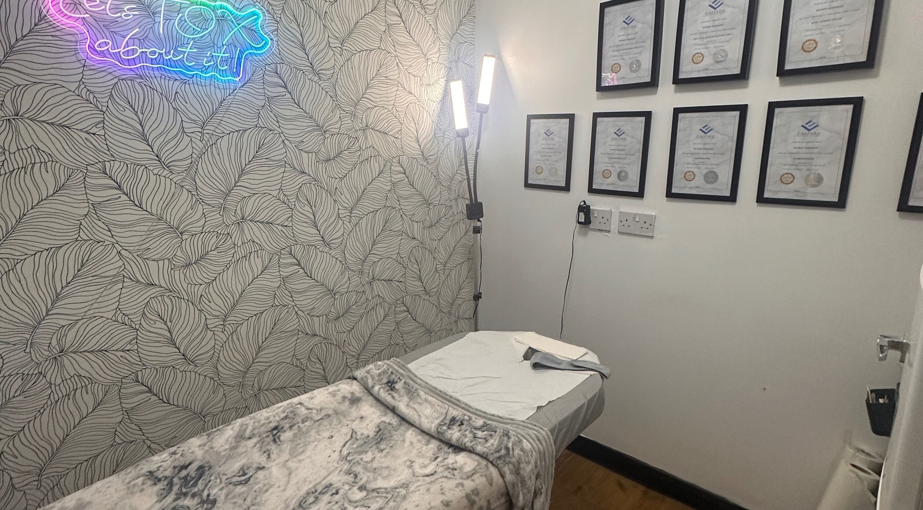 Therapy room at Beauty by Lynz in Kilsyth, Scotland, GB featuring a treatment bed and certificates.