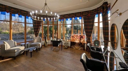 Elegant interior of Lovat Hair Nail and Beauty, Perth, Scotland, GB with plush seating and large windows.