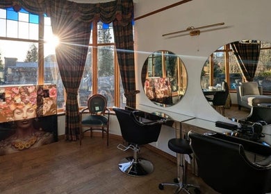 Elegant beauty station at Lovat Hair Nail and Beauty, Perth, Scotland, GB with sunlit windows and mirrors.