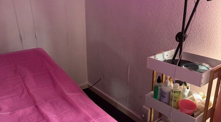 Tranquil treatment room at Deebeauty in Ashton-under-Lyne, England, GB with pink sheets and beauty products.