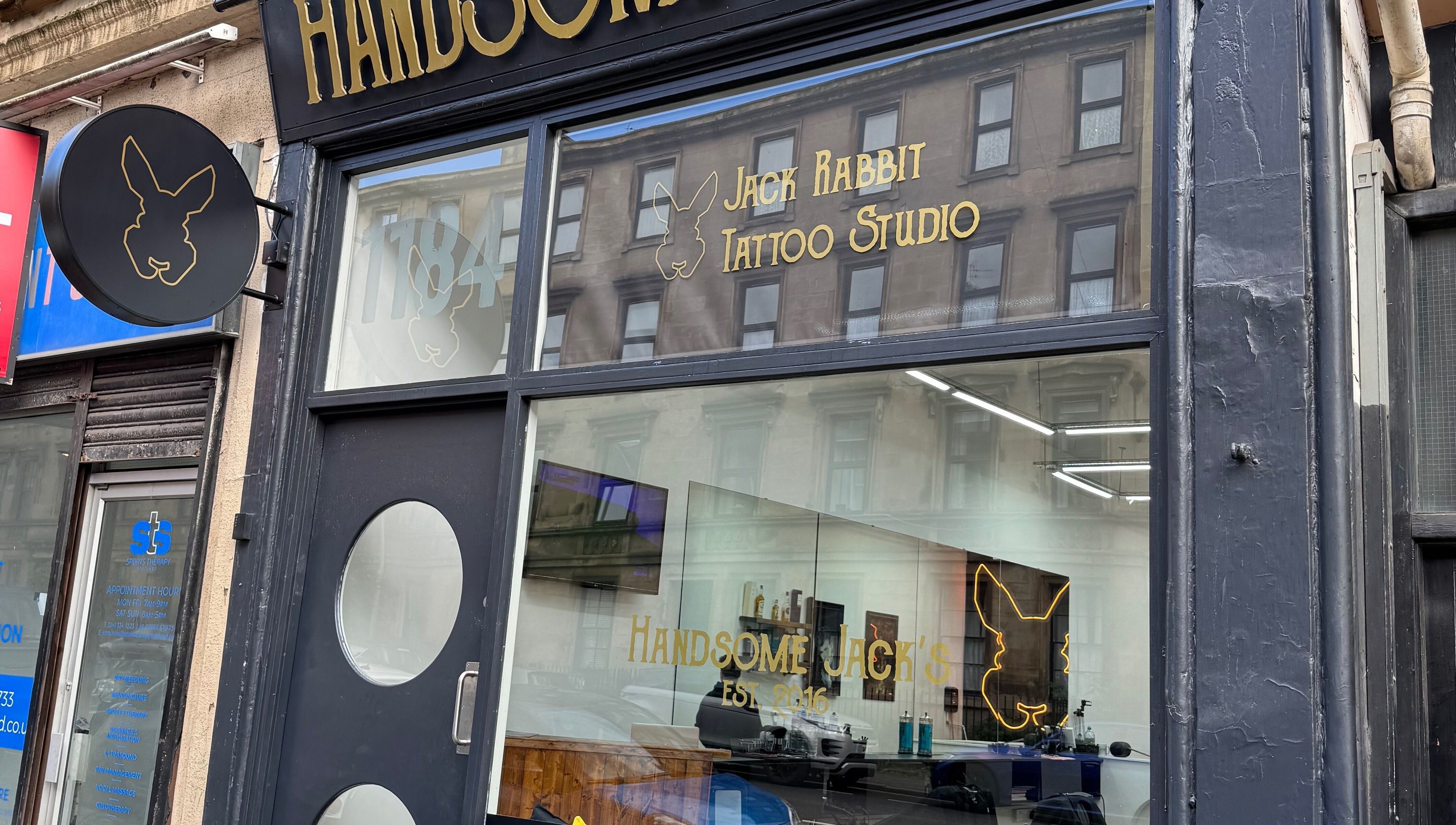 Exterior of Handsome Jacks Finnieston, a chic tattoo studio in Glasgow, Scotland, GB with modern signage.