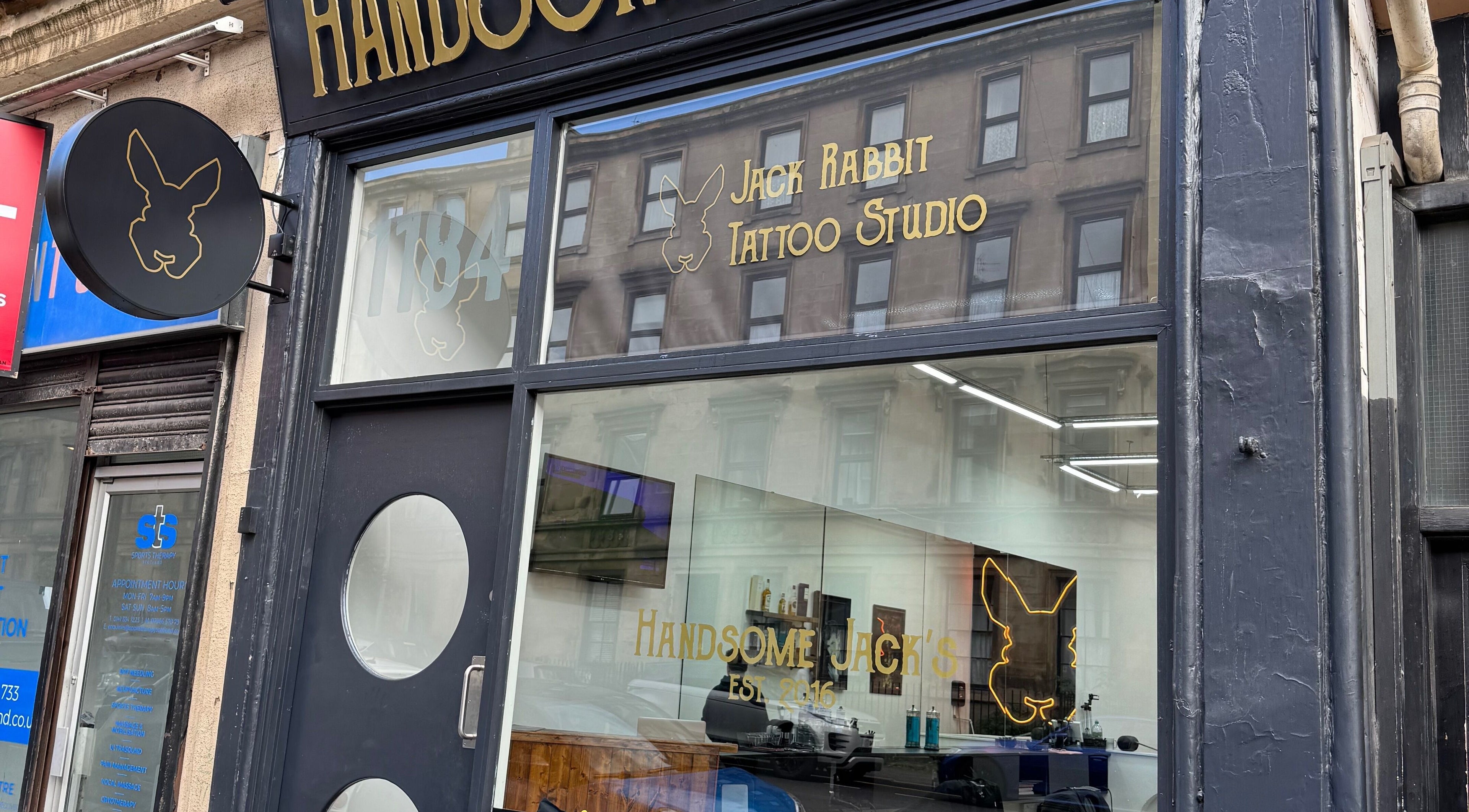 Exterior of Handsome Jacks Finnieston, a chic tattoo studio in Glasgow, Scotland, GB with modern signage.