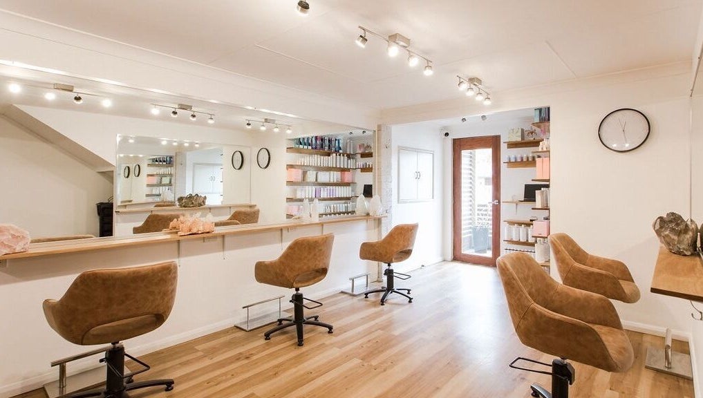 Interior of Alexander and Co Hair Studio in Wynnum, Queensland, AU, featuring stylish salon chairs and mirrors.