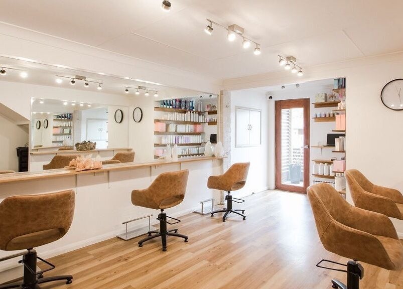 Interior of Alexander and Co Hair Studio in Wynnum, Queensland, AU, featuring stylish salon chairs and mirrors.