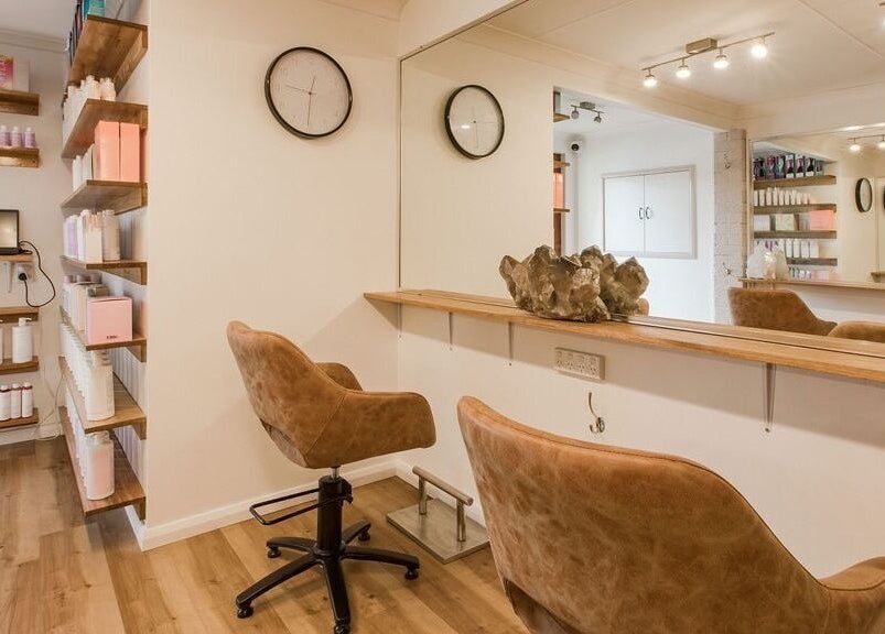 Elegant salon interior at Alexander and Co Hair Studio, Wynnum, Queensland, AU. Cozy seating and sleek design.