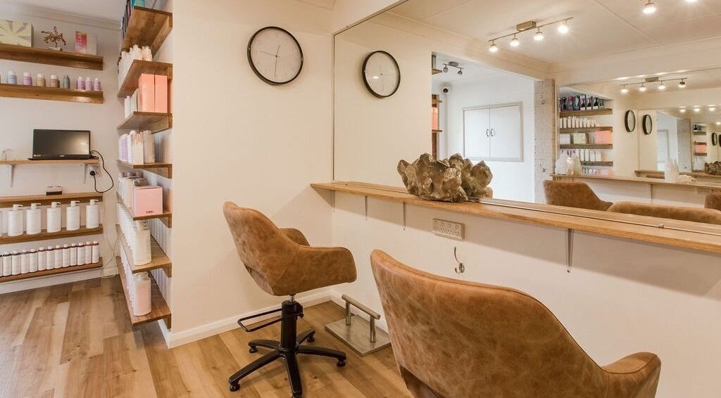 Elegant salon interior at Alexander and Co Hair Studio, Wynnum, Queensland, AU. Cozy seating and sleek design.