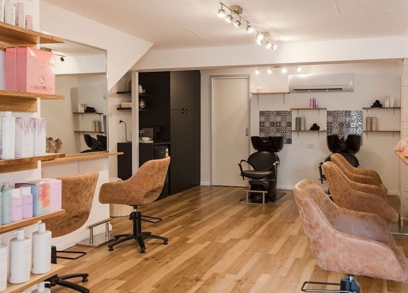 Interior of Alexander and Co Hair Studio in Wynnum, Queensland, AU, showcasing stylish seating and shelves.