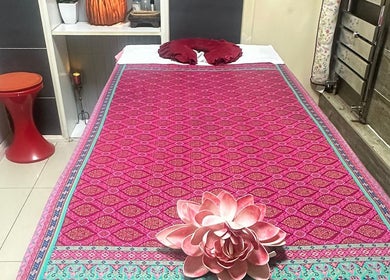 Cozy massage bed at Karaket Thai Massage, London, England, GB adorned with a lotus flower.
